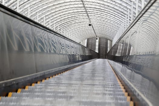 Outdoor escalator and stair with roof, close up