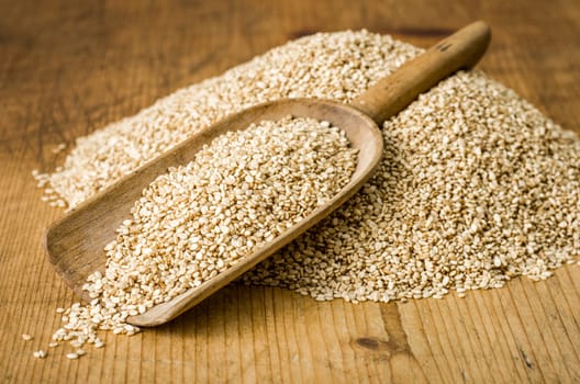 Old wooden shovel with sesame seeds
