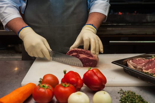 Chef cutting meat on steaks with knife