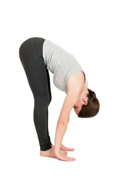 Full-body view of a young black-haired woman during yoga exercise "Standing Prevention"" Step 3 against a white background with a slight shadow"