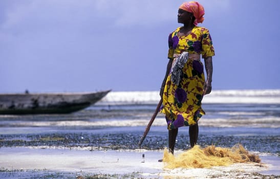 A woman works coconut fibers in the seagrass plantations in Bwejuu in the eastern island of Zanzibar in the Indian Ocean in Tanzania,Africa.