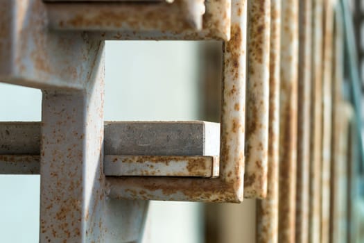 Metal staircase with stone steps and rust