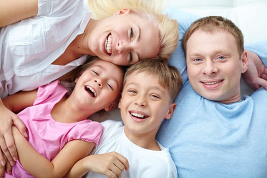 Young couple and two cute children laughing