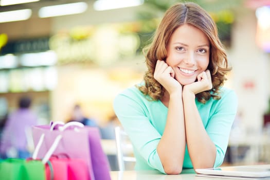 Cute female having rest after shopping