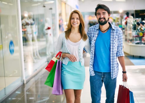Affectionate young consumers shopping in the mall