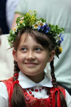 a Women in traditional dress on a Summer Festival in a Parc in the old City of Vilnius in the Baltic State of Lithuania