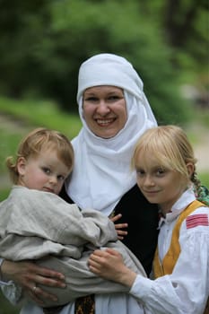 a Women in traditional dress on a Summer Festival in a Parc in the old City of Vilnius in the Baltic State of Lithuania