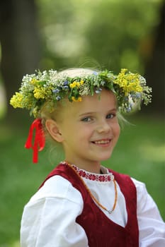 a Women in traditional dress on a Summer Festival in a Parc in the old City of Vilnius in the Baltic State of Lithuania