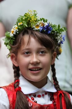 a Women in traditional dress on a Summer Festival in a Parc in the old City of Vilnius in the Baltic State of Lithuania