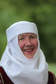 a Women in traditional dress on a Summer Festival in a Parc in the old City of Vilnius in the Baltic State of Lithuania
