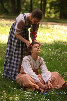 a Women in traditional dress on a Summer Festival in a Parc in the old City of Vilnius in the Baltic State of Lithuania