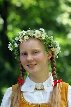 a Women in traditional dress on a Summer Festival in a Parc in the old City of Vilnius in the Baltic State of Lithuania