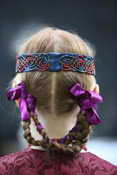 a Women in traditional dress on a Summer Festival in a Parc in the old City of Vilnius in the Baltic State of Lithuania