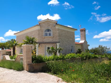 stone house and palm tree