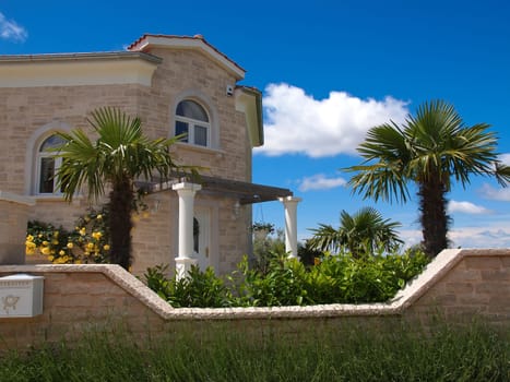 stone house and palm tree