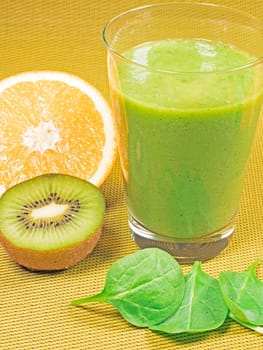 green smoothie with spinach leaves,kiwi and orange