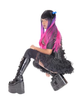 A beautiful African American steampunk woman in a black corset .kneeling in a short skirt and long boots, isolated for white background..