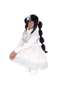 A lovely African American woman crouching on the floor in a baby doll.dress and long black hair, isolated for white background..