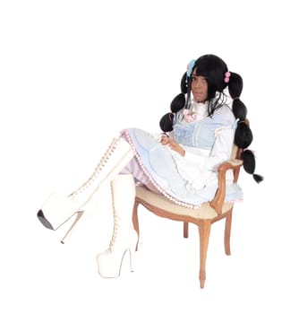 A lovely African American woman sitting on an armchair in a baby doll.dress and long black hair, isolated for white background..