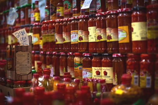 Several pots of red pepper, stacked for sale on the market.