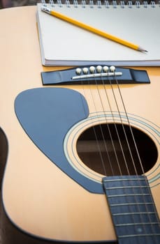 Yellow Acoustic Guitar On Wooden Table, stock photo