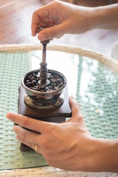 Hand On Grinding Roasted Coffee, stock photo