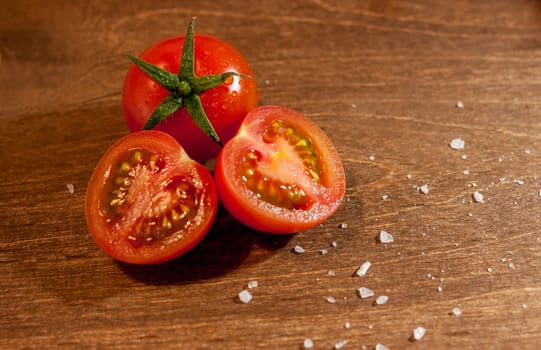 fresh ripe cherry tomatoes on wooden background salt free space