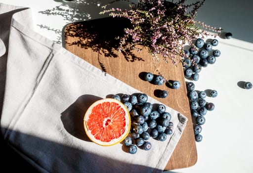 still life top view blueberries red grapefruit and violet flower
