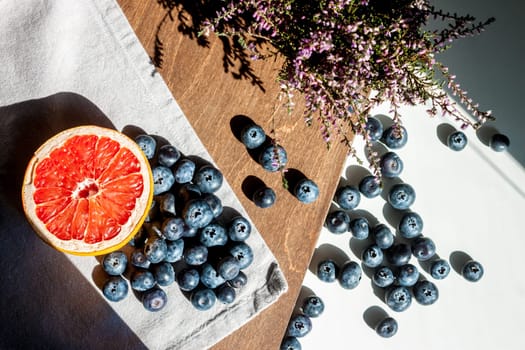 still life top view blueberries red grapefruit and violet flower