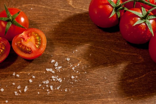 fresh ripe cherry tomatoes on wooden background salt free space