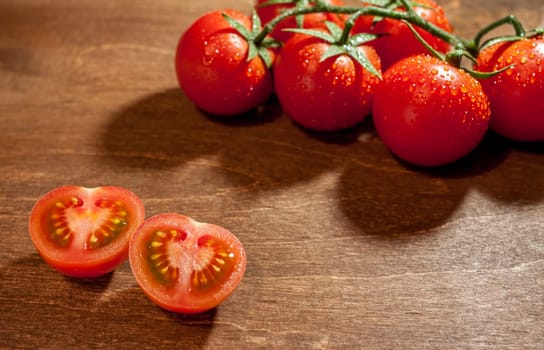 fresh ripe cherry tomatoes on wooden background salt free space