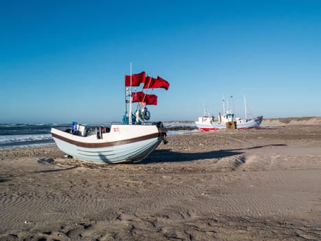 Fishing village with the old wooden fishing boats pulled up on the beach