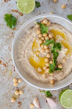 Homemade hummus with olive noel and fresh parsley