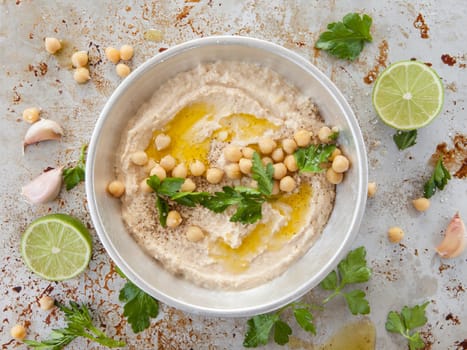 Homemade hummus with olive noel and fresh parsley
