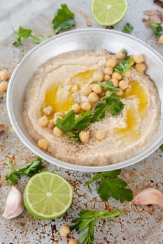 Homemade hummus with olive noel and fresh parsley