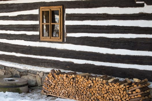 Wall of the timbered cottage and window - wood texture
