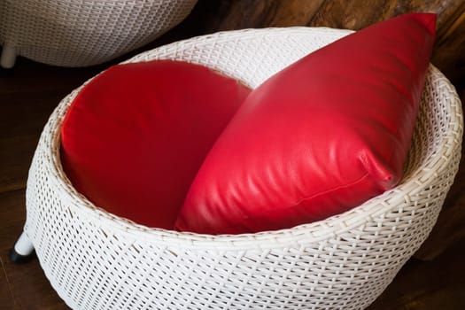 Red Pillow With Plastic Rattan Furniture, stock photo
