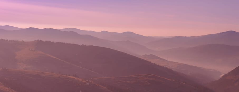 Beautiful pink morning sunrise in the mountain landscape. Carpathians, Western Ukraine, Europe. Panorama photo.