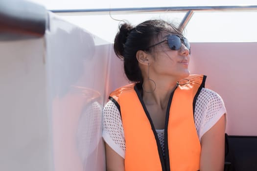 Beautiful girl on the speed boat and looking beautiful sea
