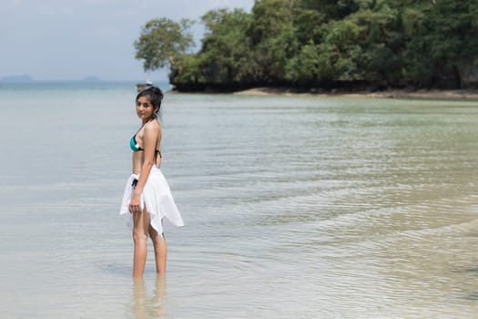 Beautiful young girl on tropical island beach
