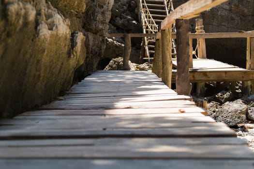 A close up shot of some old weathered beach stairs covered in sand