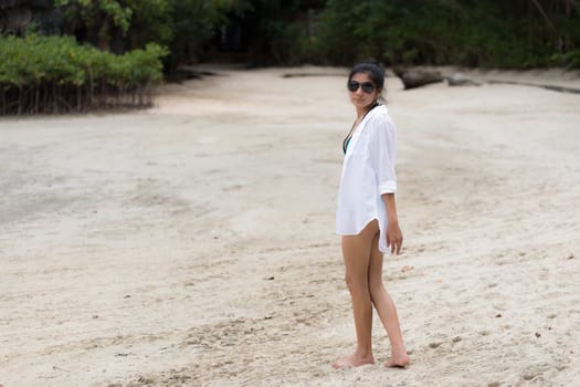 Beautiful young girl on tropical island beach