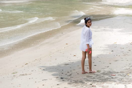 Beautiful young girl on tropical island beach