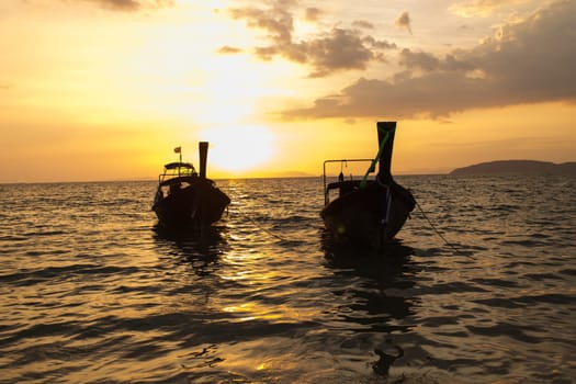 Traditional thai longtail boat at sunset on the Beach. Thailand, Krabi province