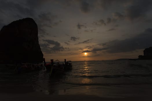 Traditional thai longtail boat at sunset on the Beach. Thailand, Krabi province