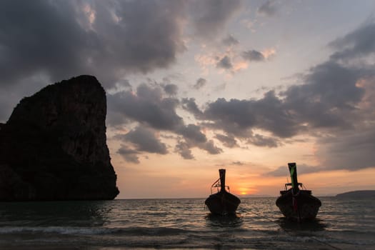 Traditional thai longtail boat at sunset on the Beach. Thailand, Krabi province