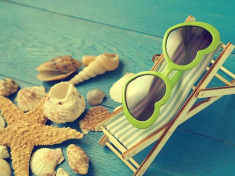 Vacation concept background with seashells and starfisch on a blue wooden background