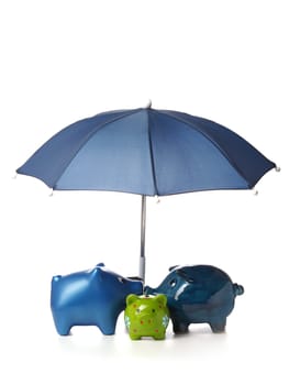 Protect your savings, Three piggy bank with an umbrella on a white background
