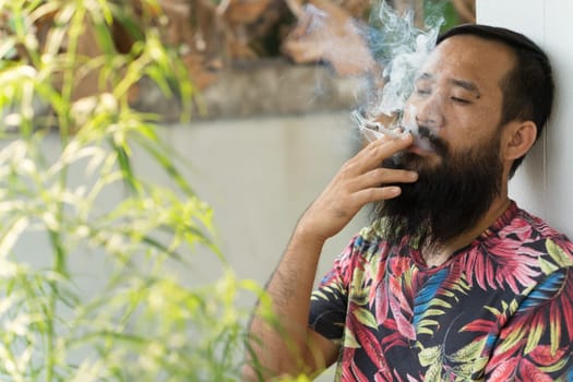 Portrait of adult man who is smoking cigarette