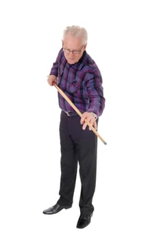 A handsome senior citizen standing isolated for white background and.praying his billiard game..